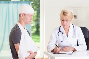 Horizontal vieiw of boy visiting doctor after accident